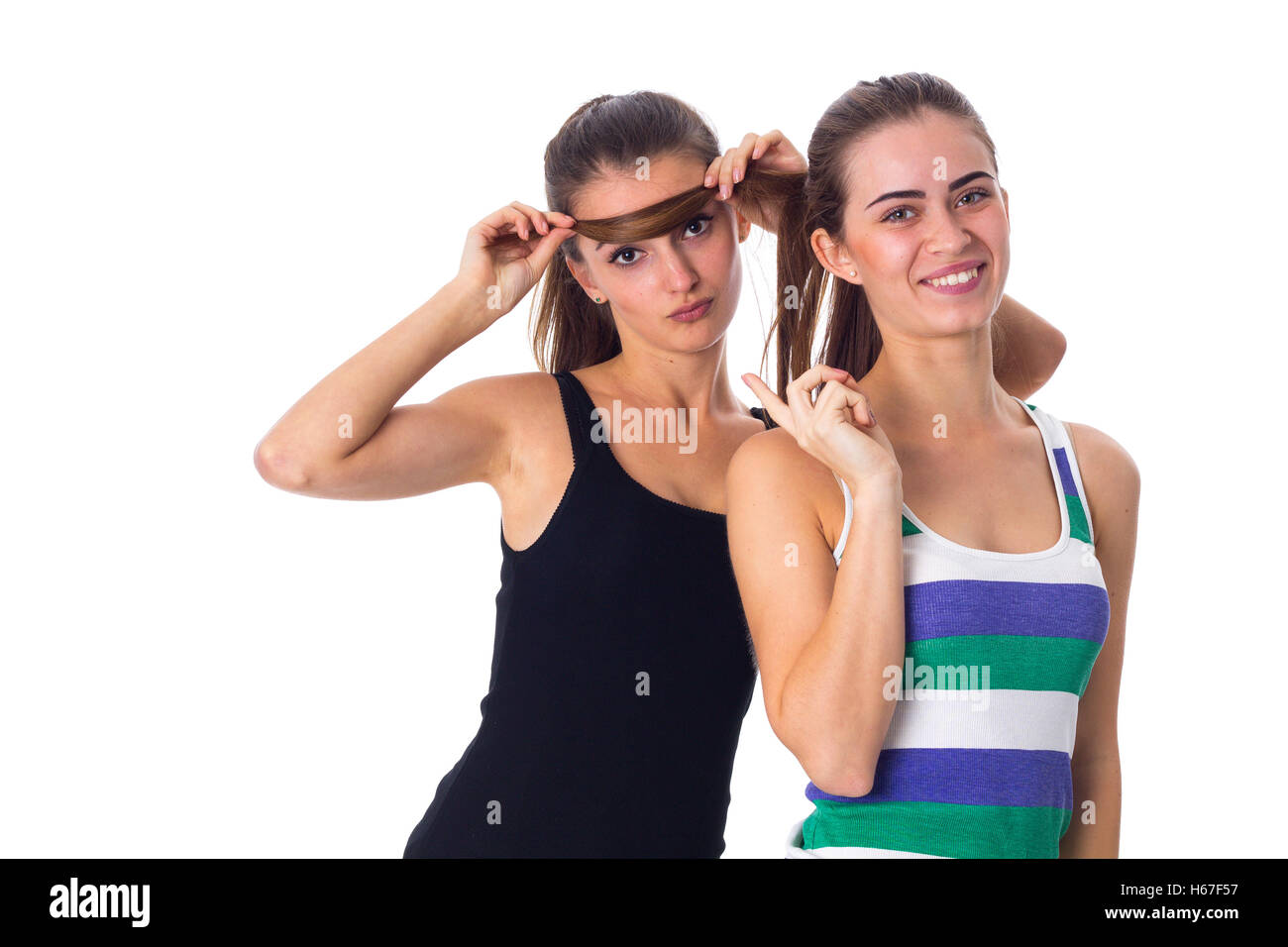 Young woman holding another woman's hair Stock Photo
