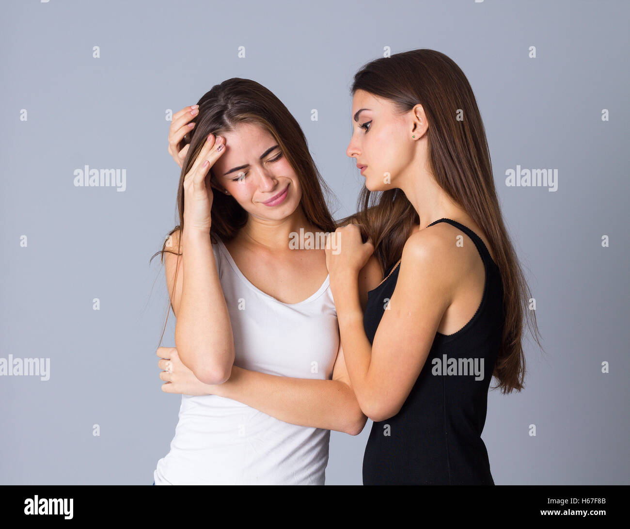 Both Crying Standing embracing crying sadness hi-res stock photography and images ...