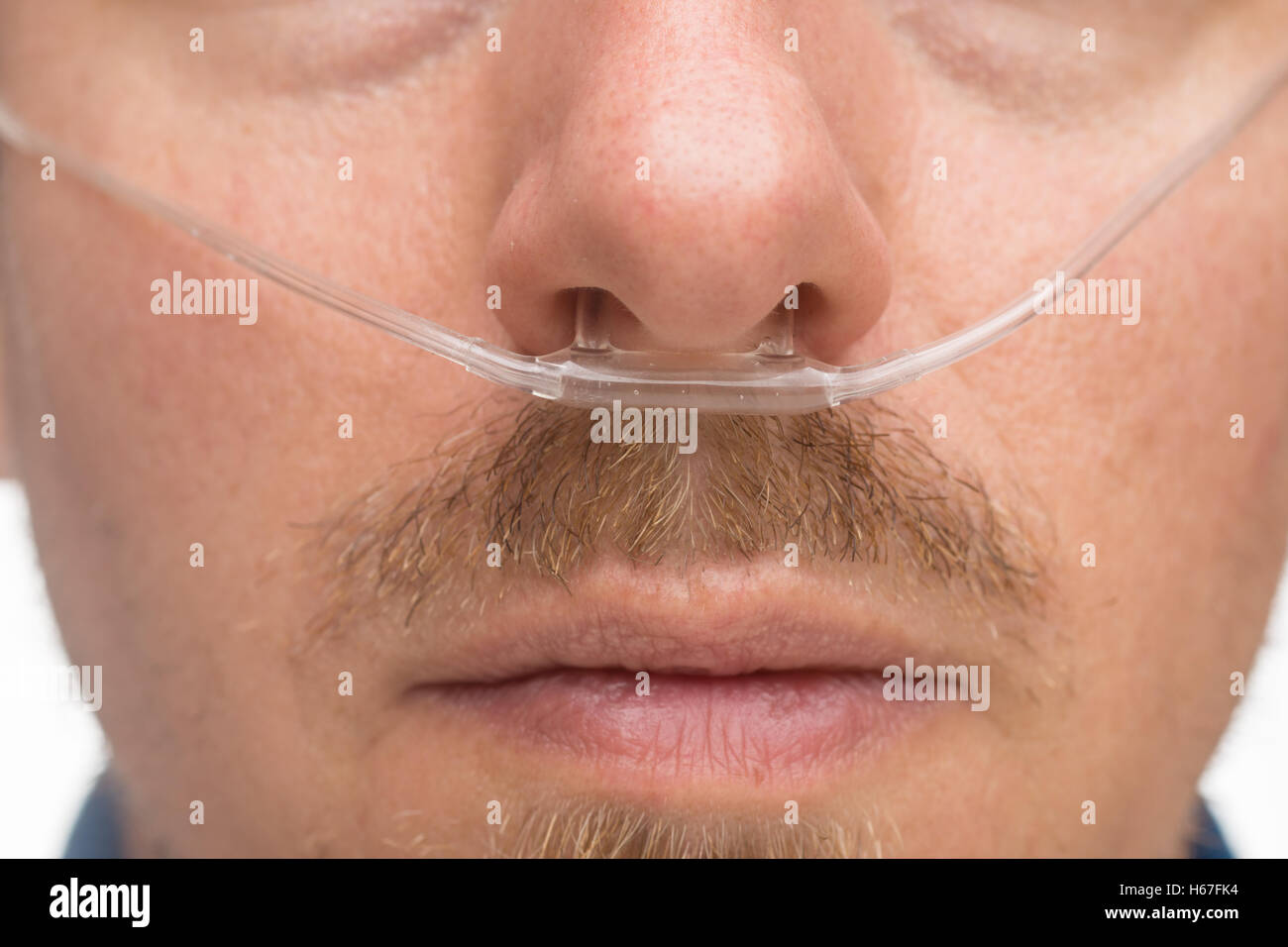 Nasal cannula for oxygen delivery on a bearded man Stock Photo