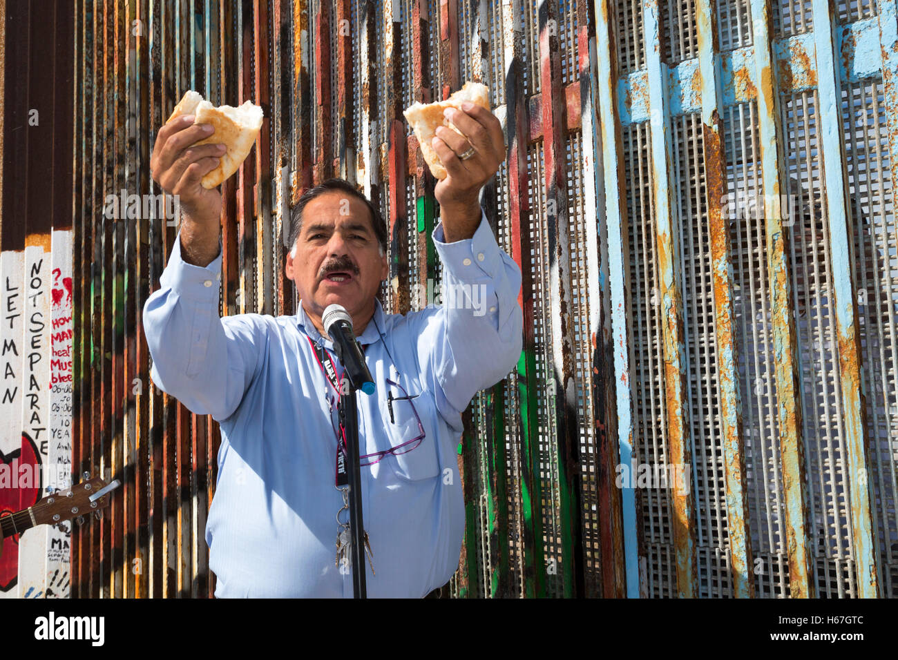Tijuana, Mexico - Methodist Pastor Guillermo Navarrette leads Sunday interfaith worship at the U.S.-Mexico border fence. Stock Photo