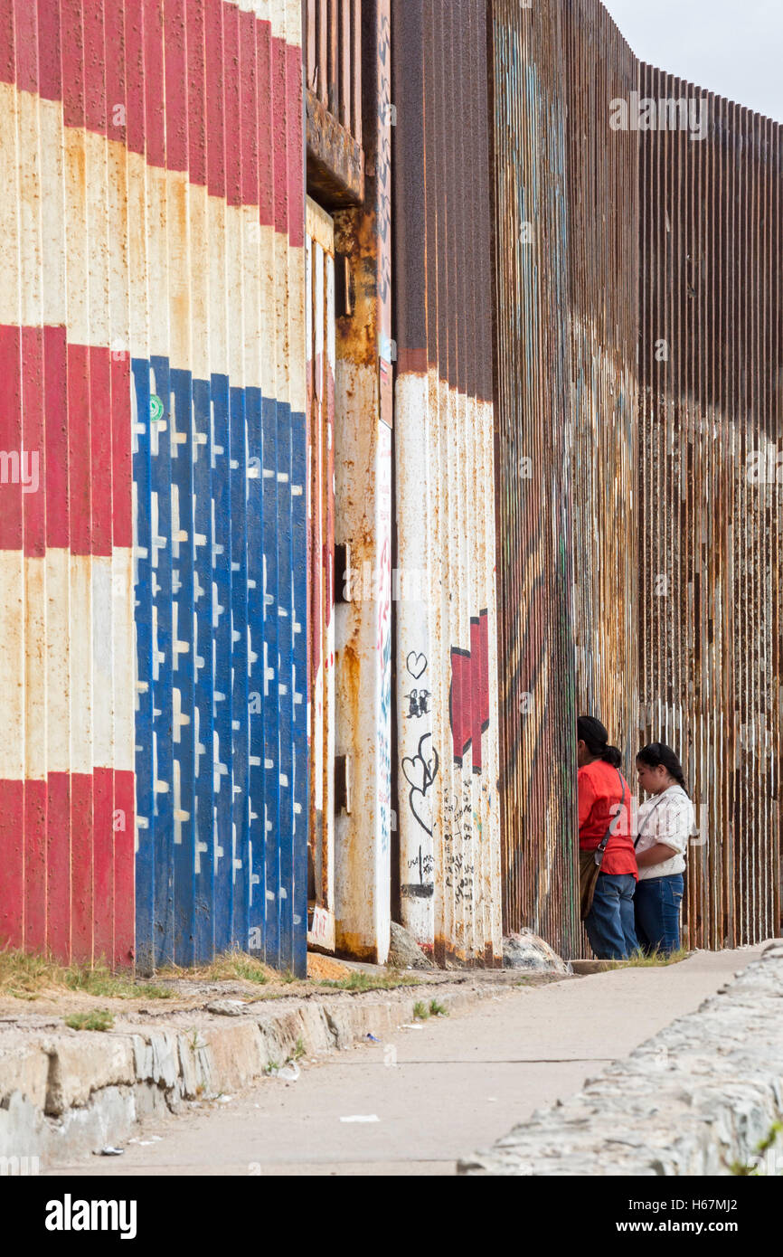Tijuana, Mexico - Family members separated by deportation visit through the U.S.-Mexico border fence. Stock Photo