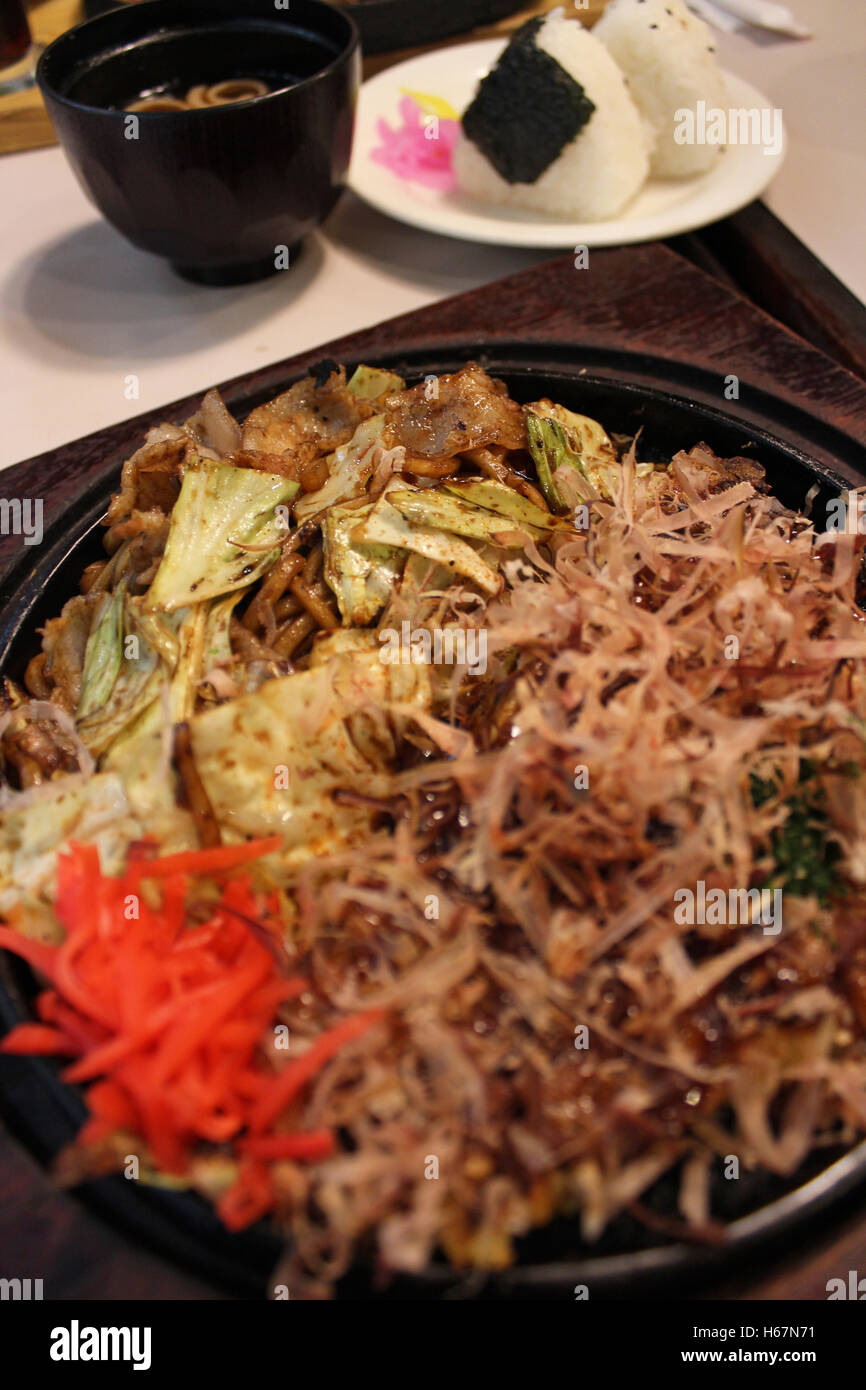 Okonomiyaki, Japanese Pizza topped with bonito flakes and sliced