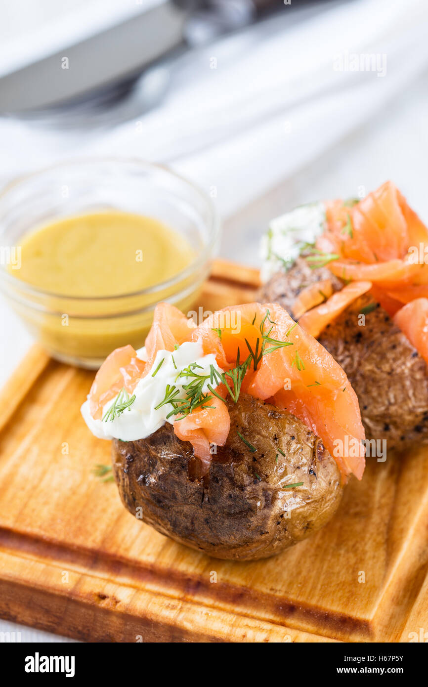 Crispy jacket potatoes with light soft cheese and smoked salmon fillet