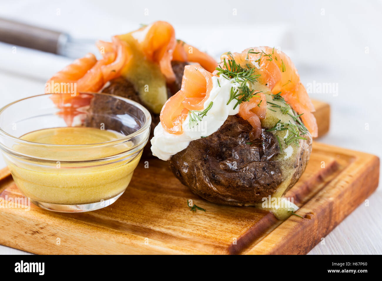 Crispy jacket potatoes with light soft cheese, smoked salmon fillet and