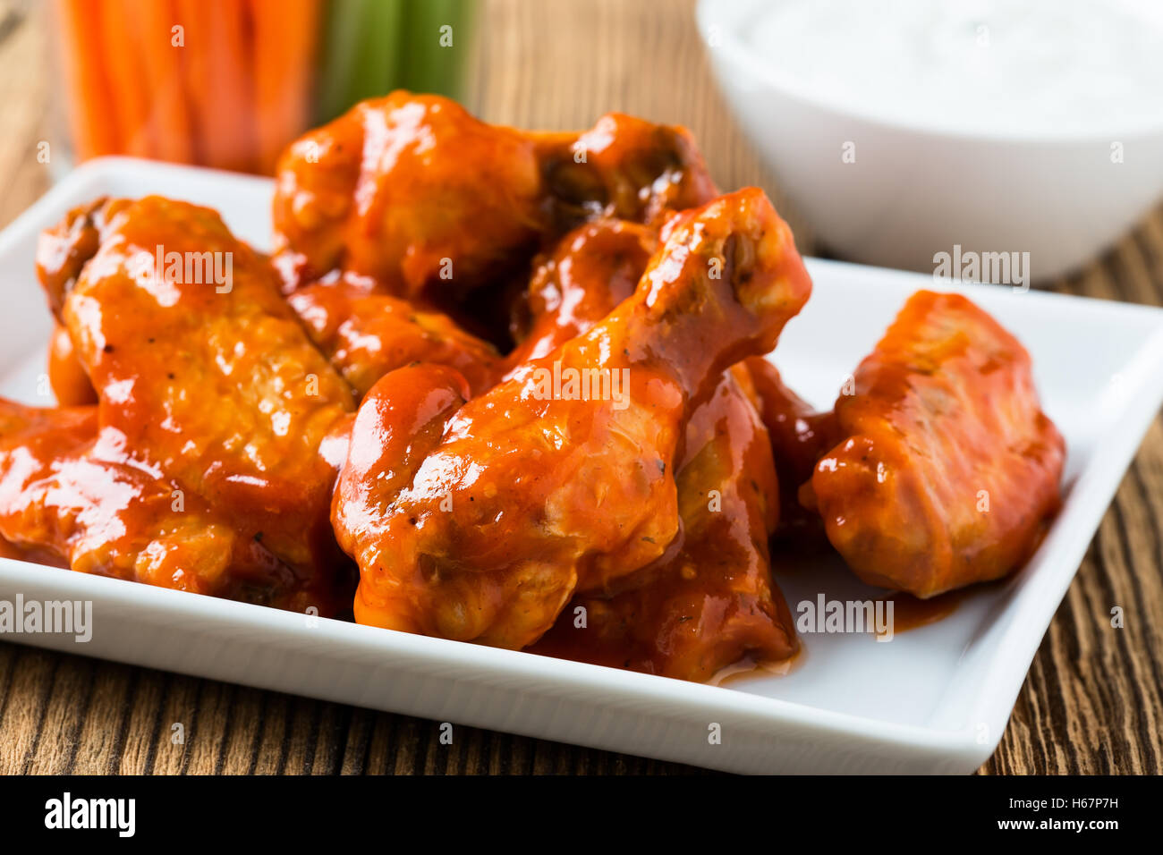 Buffalo chicken wing with cayenne pepper sauce served hot with celery