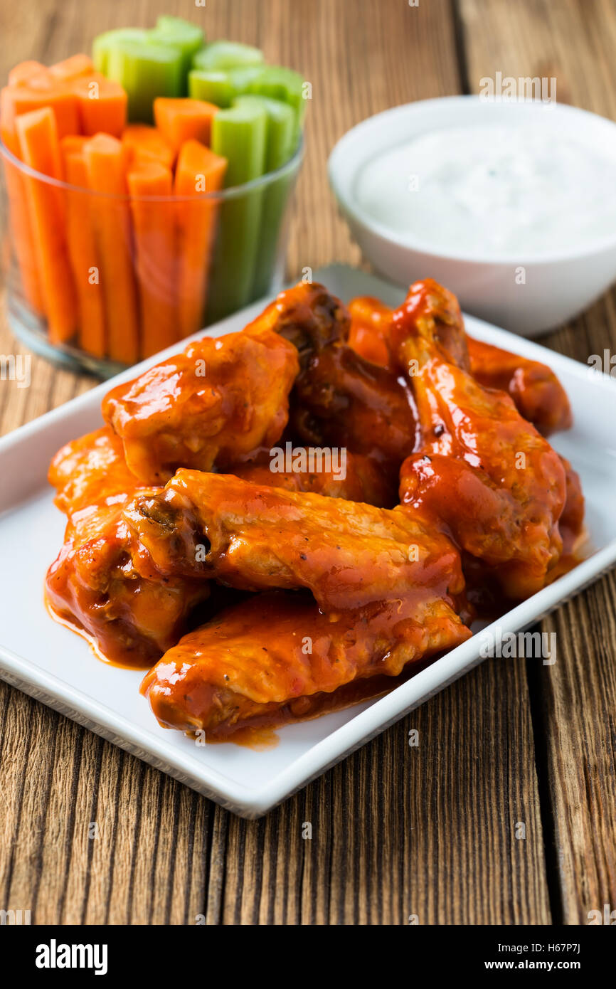 Buffalo chicken wing with cayenne pepper sauce served hot with celery