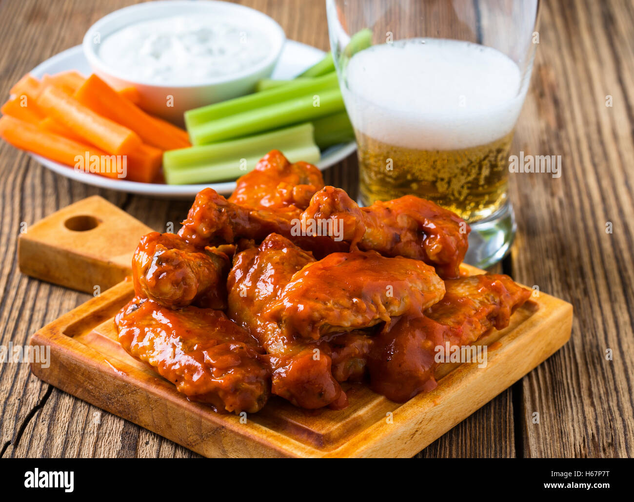 Buffalo chicken wing with cayenne pepper sauce served hot with celery
