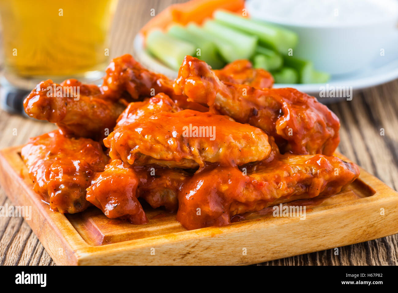 Buffalo chicken wing with cayenne pepper sauce served hot with celery
