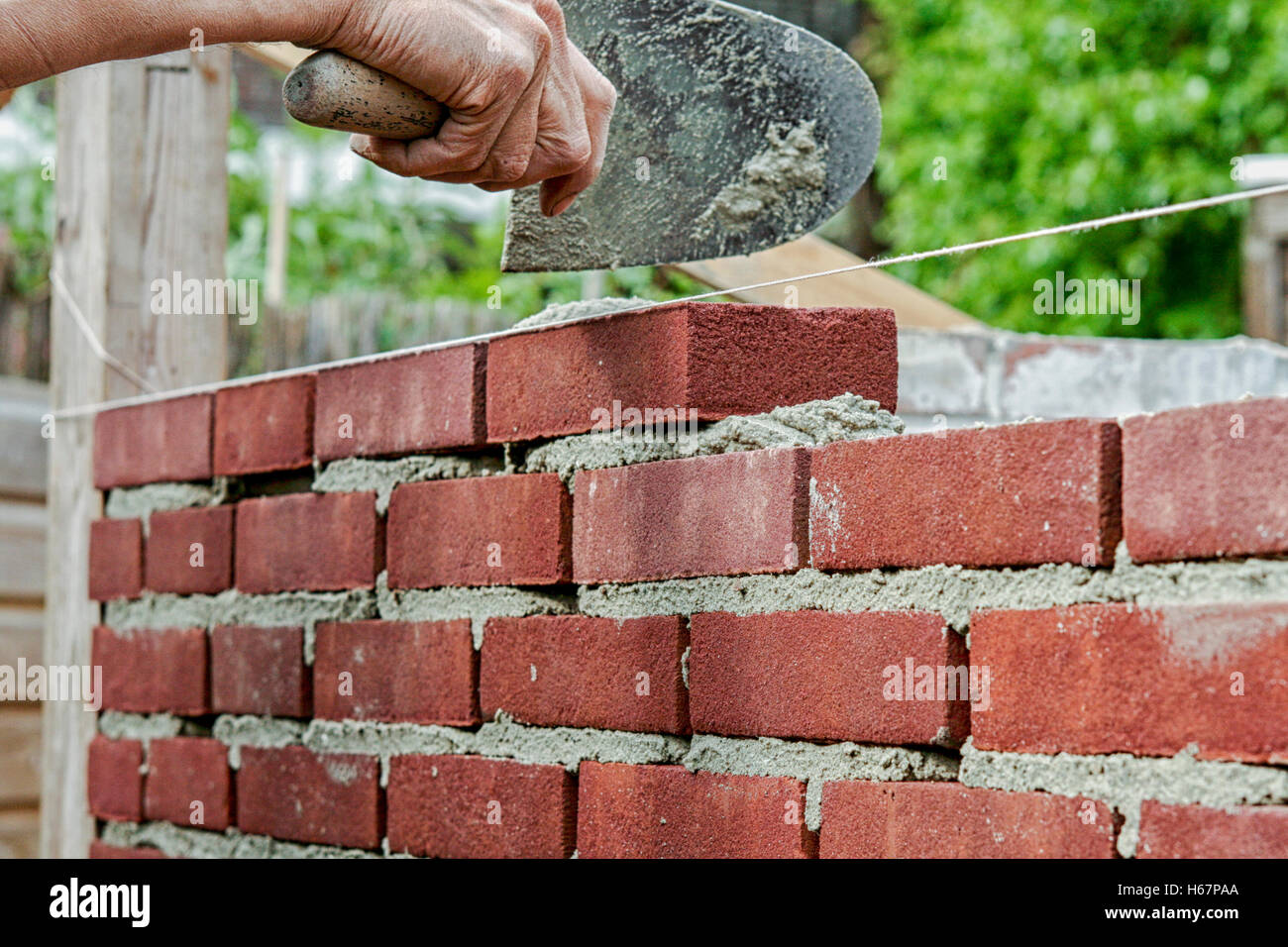 Bricklayer on construction site Stock Photo Alamy