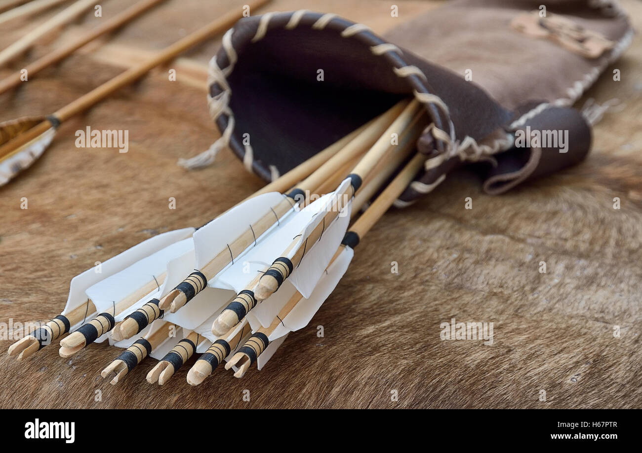 ancient quiver with arrows over the table Stock Photo