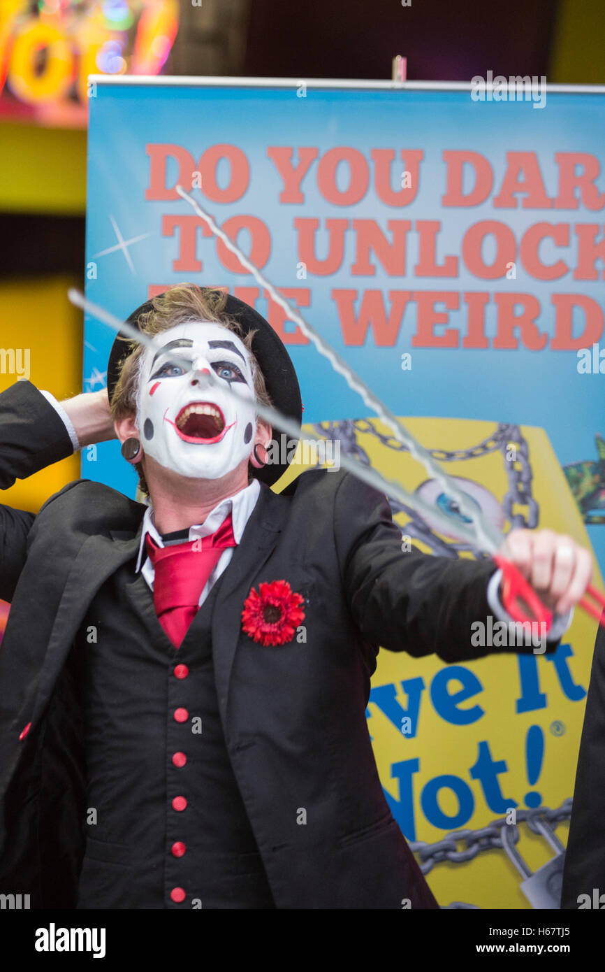 London, UK. 25 October 2016. Tyler Sutter of 20 Penny Circus performing sword eating. Contemporary vaudevillian variety act 20 Penny Circus perform stunts at the book launch for the 2017 edition of Ripley's Believe It or Not! at Ripley's London Pavilion store in Piccadilly Circus. Following hot on the heels of last year's Top 10 bestseller, the 2017 edition offers a completely new compendium of strange but true facts and amazing stories. Stock Photo