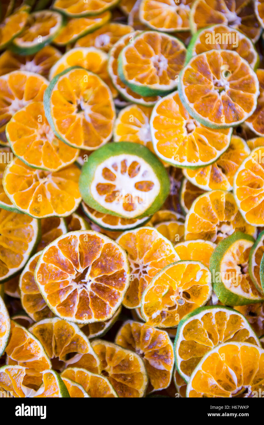Stack of dried and sliced mandalin limes (known elsewhere as Mandarin or Rangpur limes) on display in a market in Turkey Stock Photo