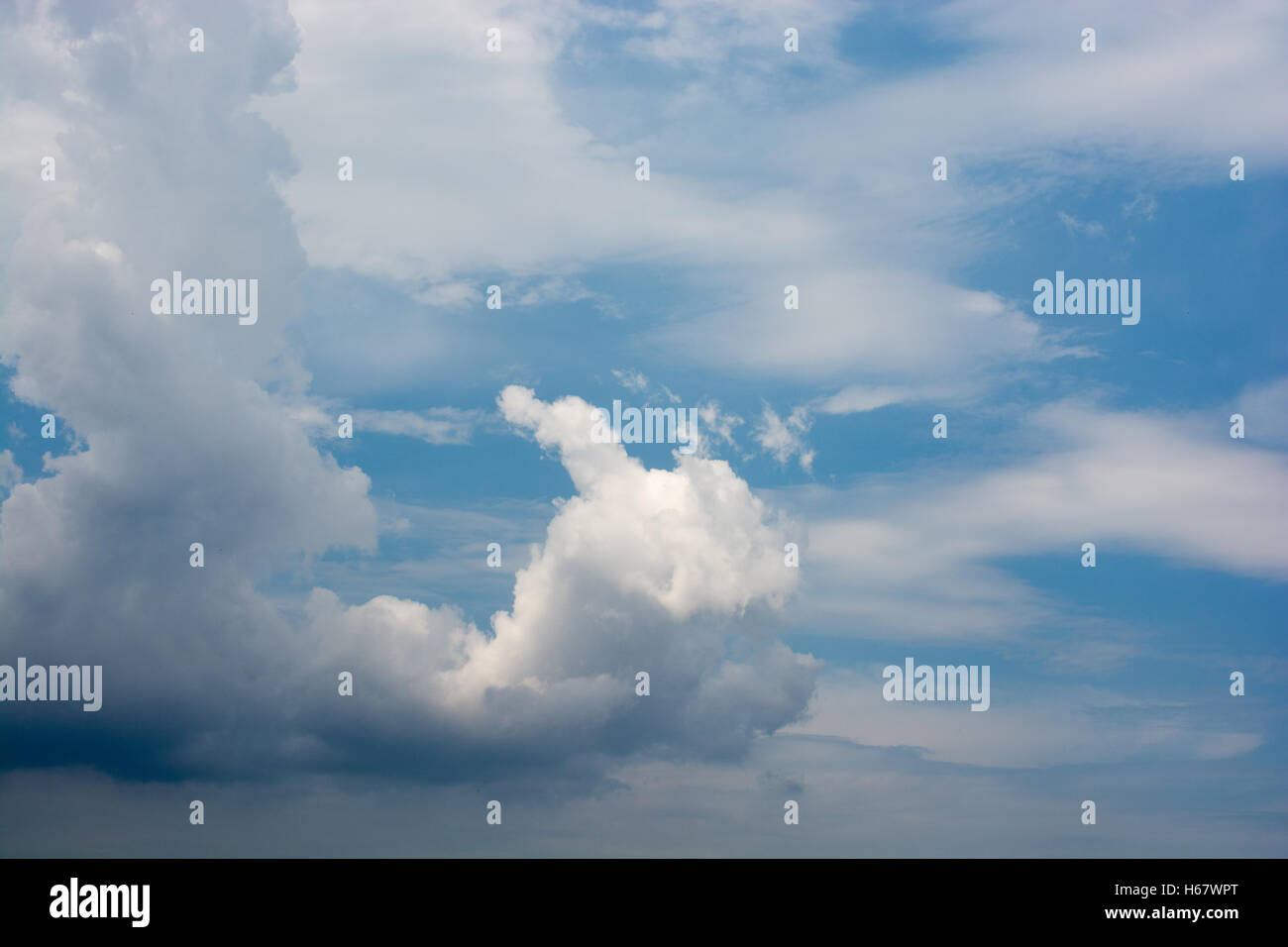 Blue cloudy sky with white and grey clouds Stock Photo - Alamy