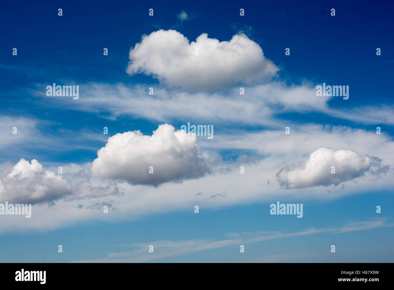 Blue cloudy sky with white and grey clouds Stock Photo - Alamy