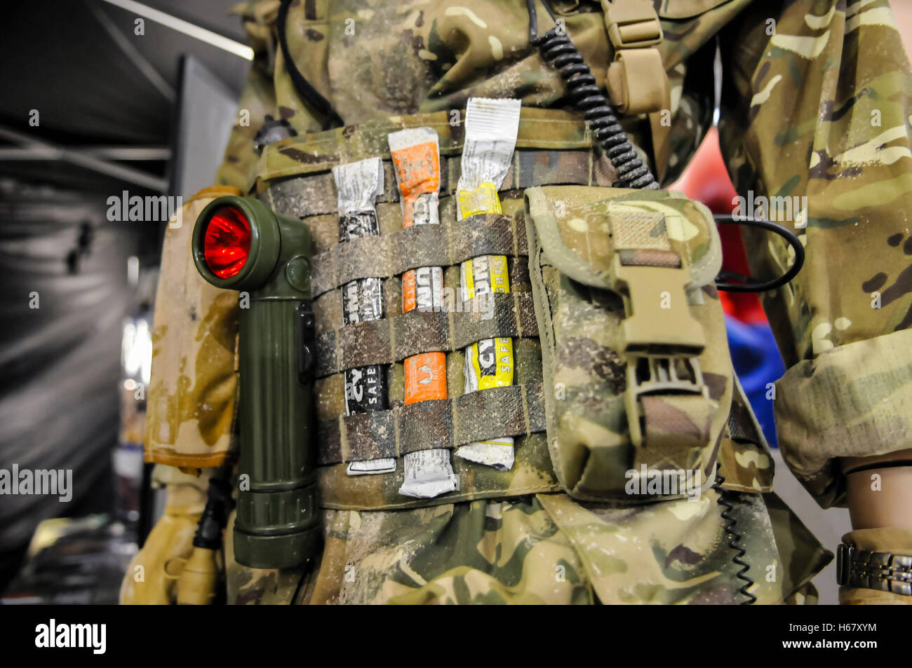 Soldier carries utility belt with a torch with red filter, and Cyalume glow sticks for nightime operations. Stock Photo
