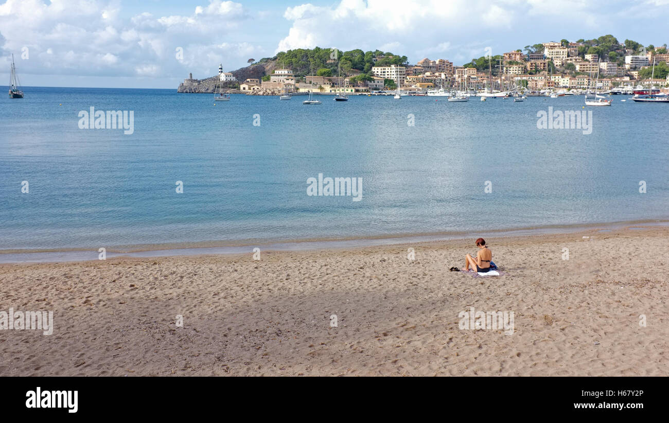 A woman sunbathes on a deserted beach in Soller, Majorca Stock Photo