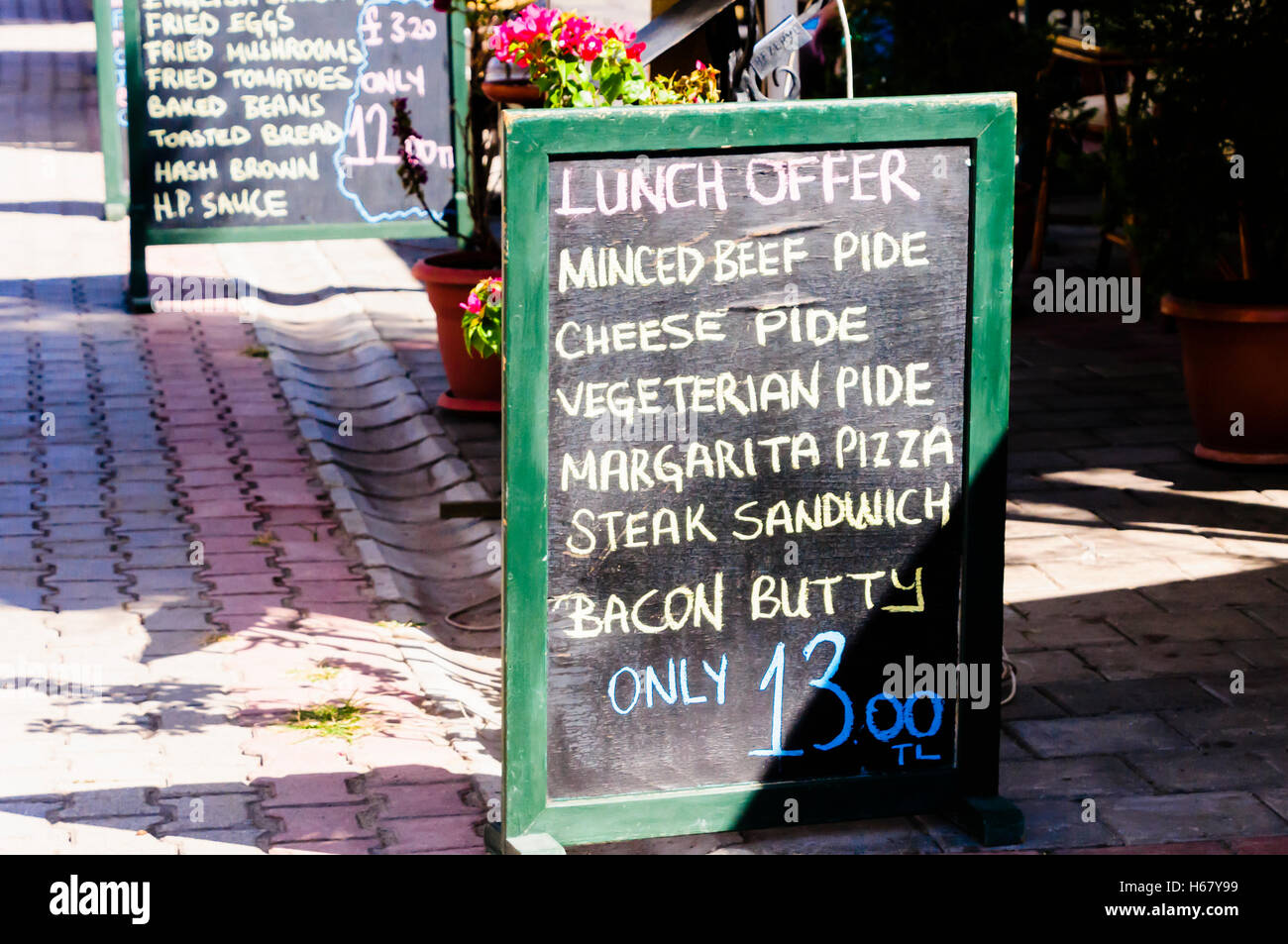 Blackboard at a restaurant with the lunch menu offers including minced beef, cheese, vegetarian, margarita pide (Turkish pizza) Stock Photo