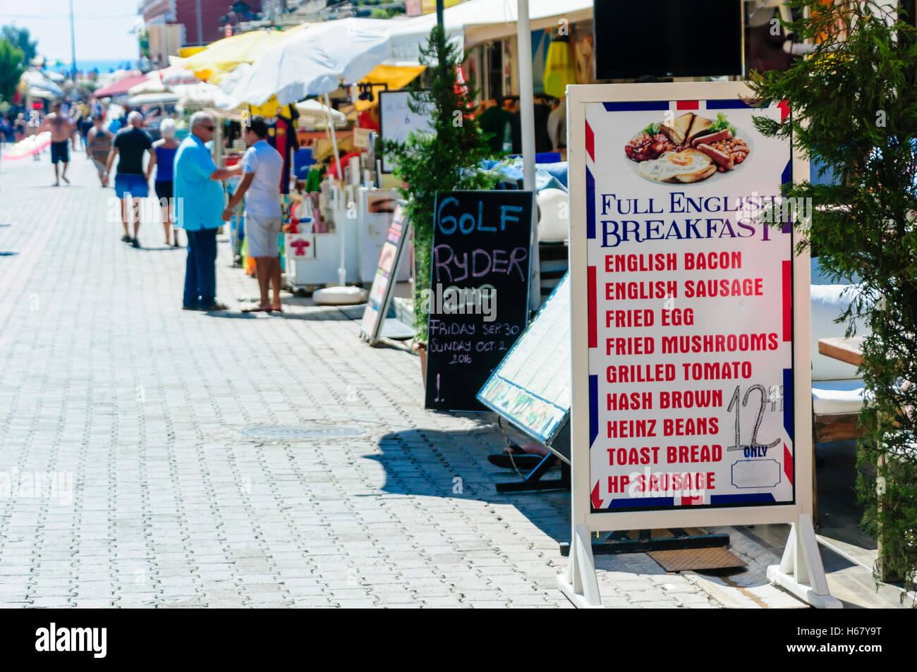 Row of restaurants, cafes and bars in Oludeniz, offering breakfasts and meals catering for English British tourists. Stock Photo