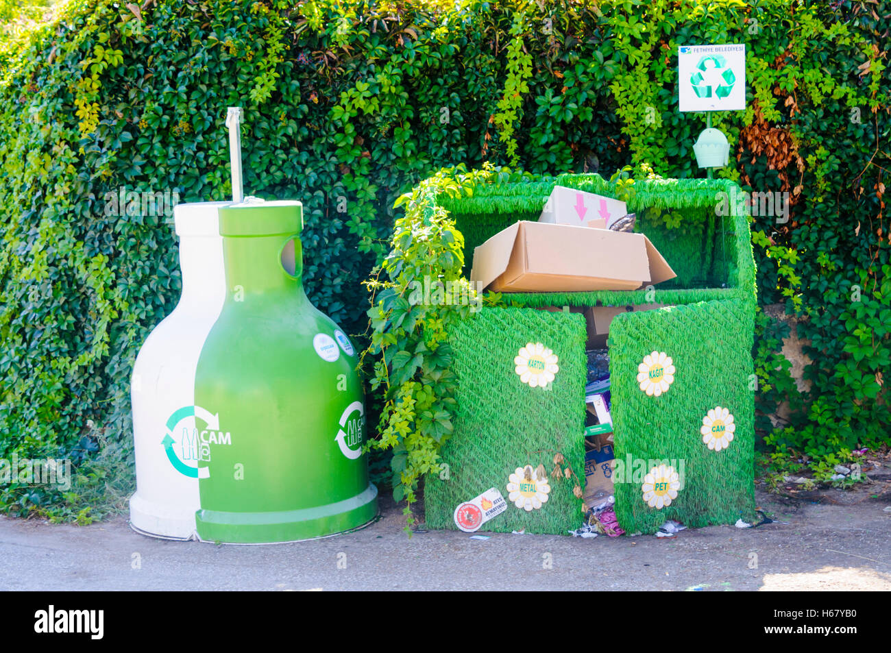 Recycling centre with a plastic container, and a bin covered in artificial grass to make it more attractive Stock Photo