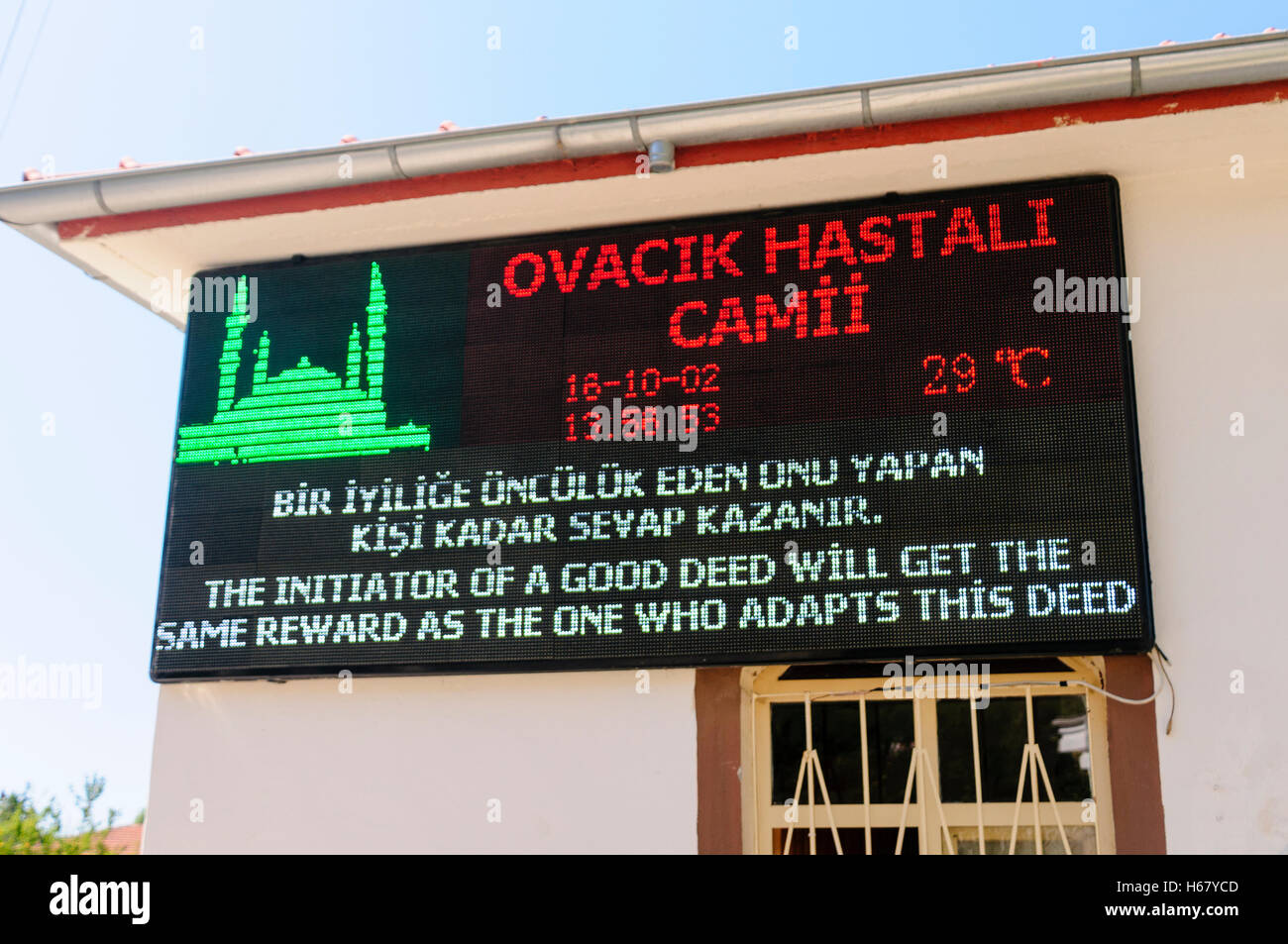 LED sign outside a mosque saying 'The initiator of a good deed will get the same reqard as the one who adapts this deed' from th Stock Photo