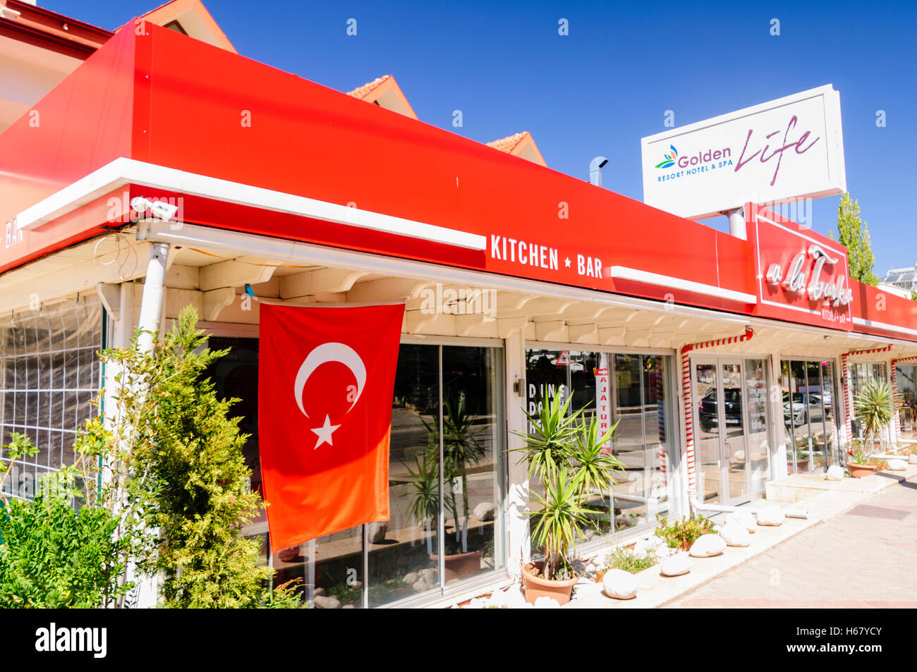 Red Turkish flag hanging outside a restaurant Stock Photo