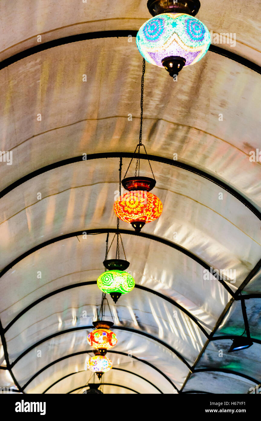Glass lampshades hanging from the roof of Fethiye Market, Turkey Stock Photo