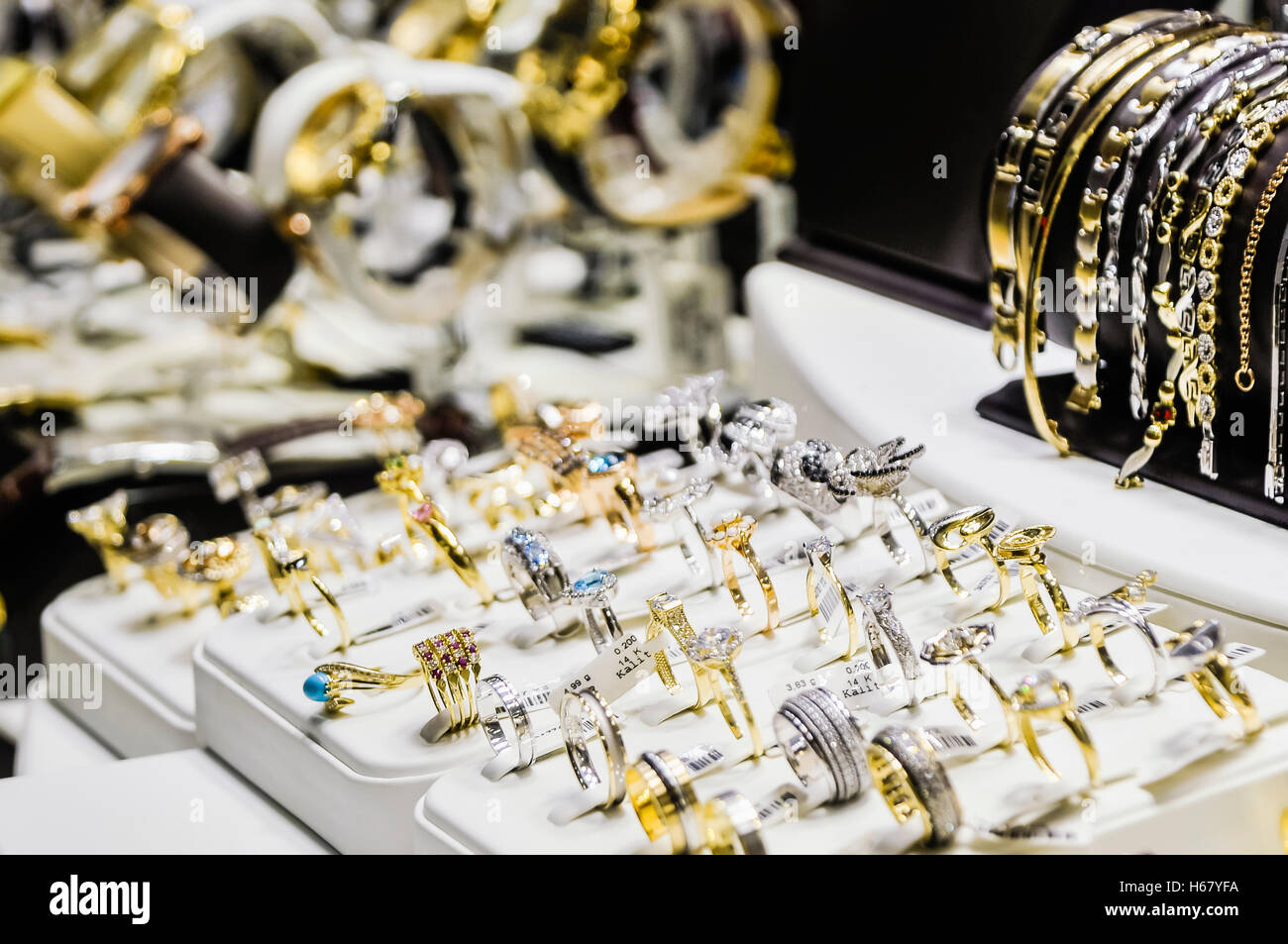 Diamond rings and bracelets on display in a jeweller's window. Stock Photo