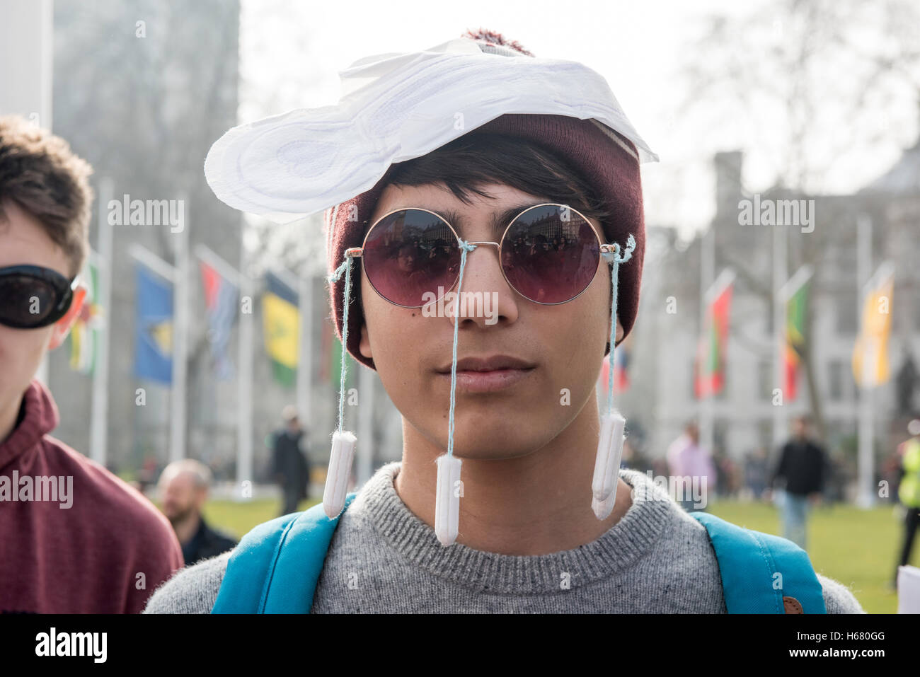 Young man wearing tampons over his face and a sanitary pad over the head is  protesting against the Tampon Tax Stock Photo - Alamy