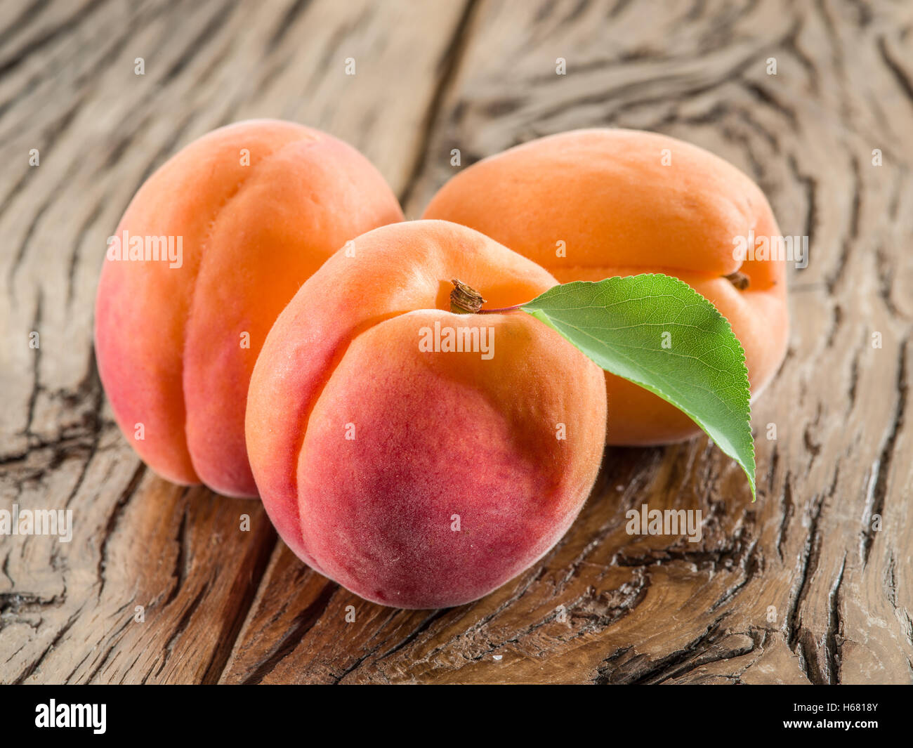 Apricots on the old wooden table. Stock Photo