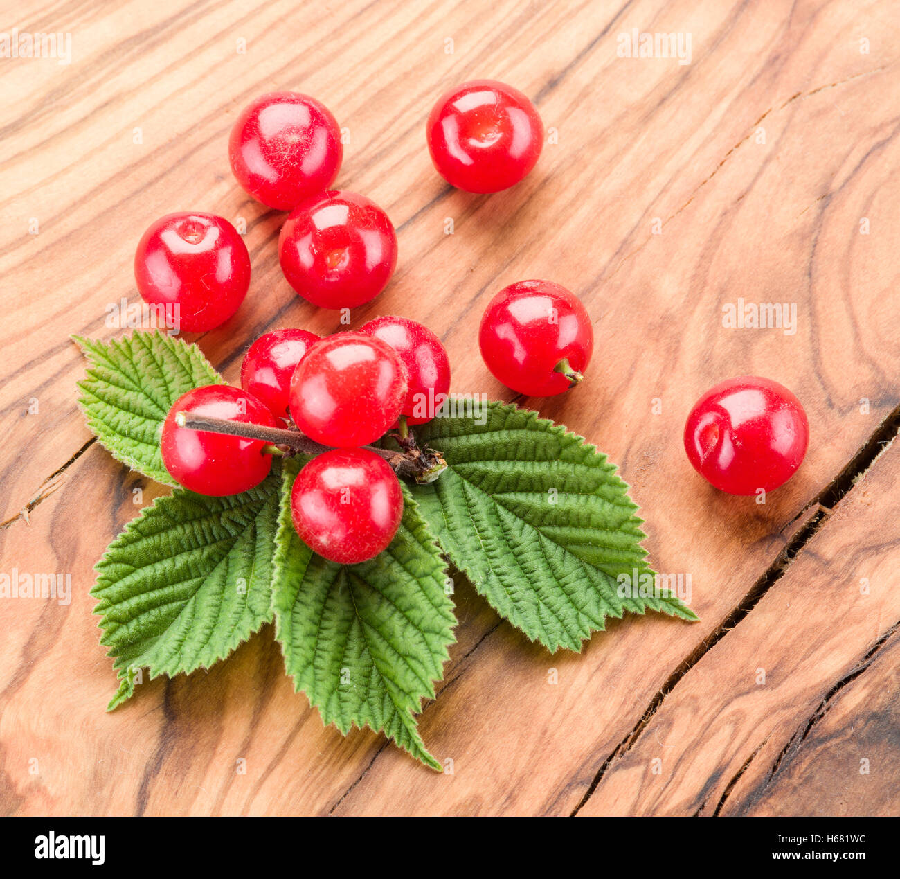 Nanking or felted cherry fruits with leaves on the wooden table. Stock Photo