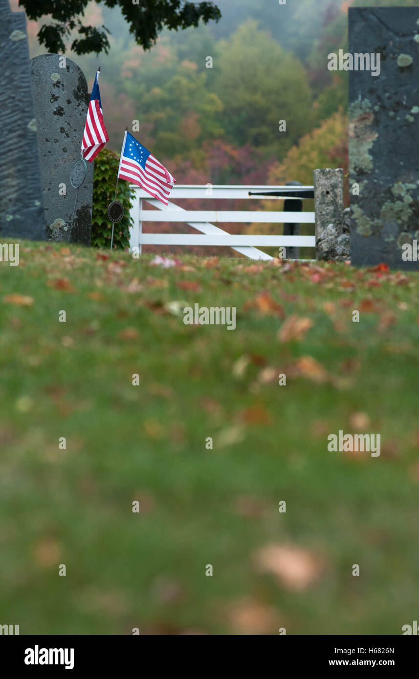 American Betsy Ross flags by the graves of Revolutionary War soldiers in a cemetery in Amherst, New Hampshire, USA. Stock Photo