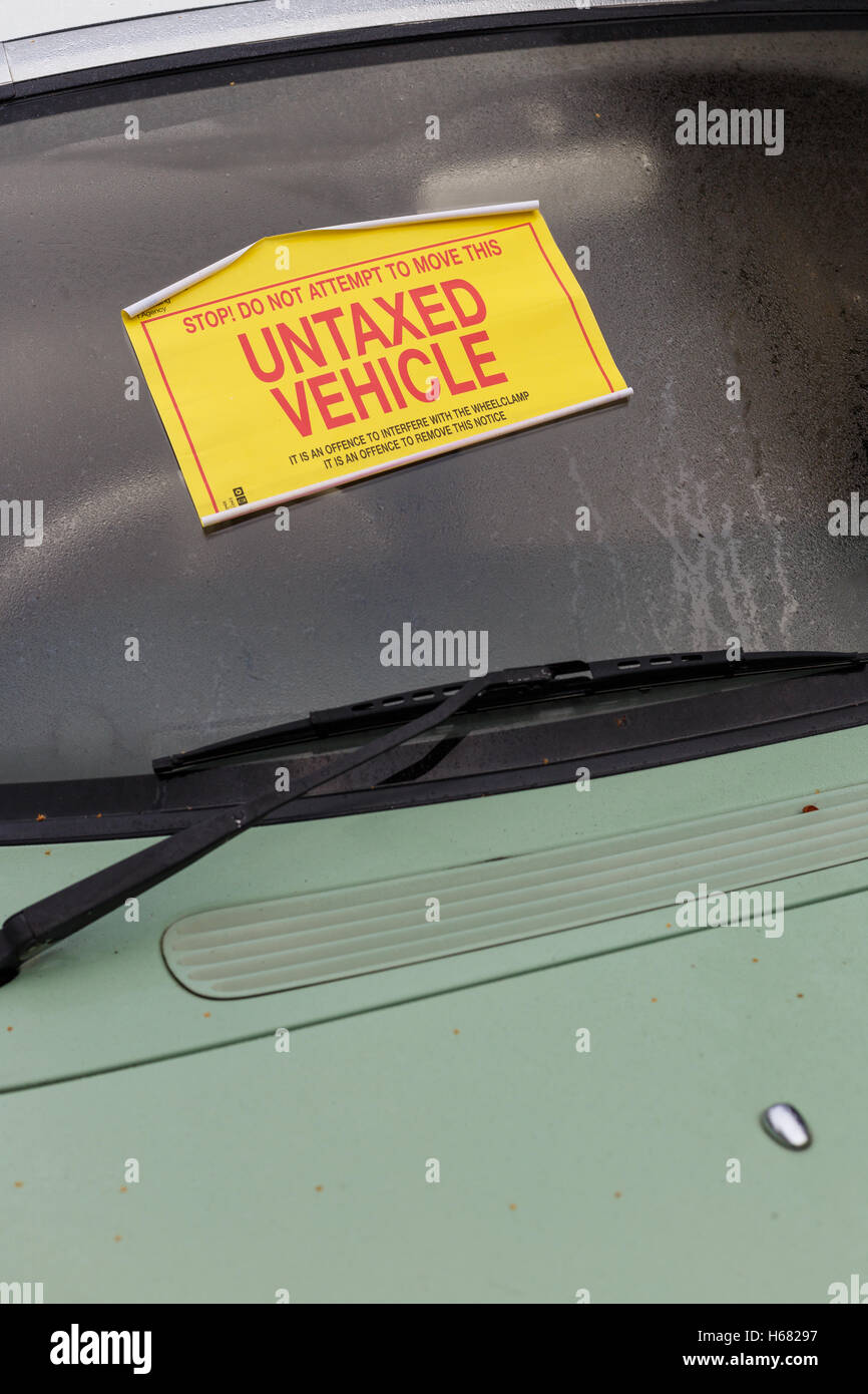 Nissan Figaro car with 'Untaxed Vehicle' sticker attached to windshield. Stock Photo