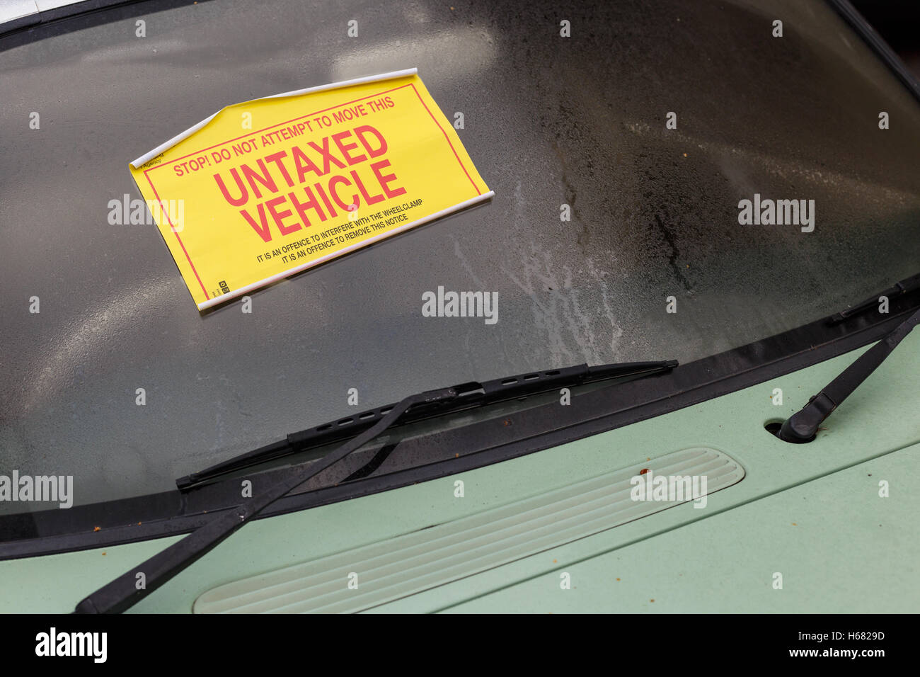A Nissan Figaro car with 'Untaxed Vehicle' sticker attached to windshield. Stock Photo