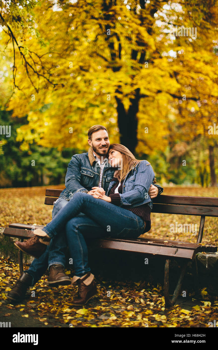 Loving and romantic couple on a bench in the autumn park Stock Photo ...