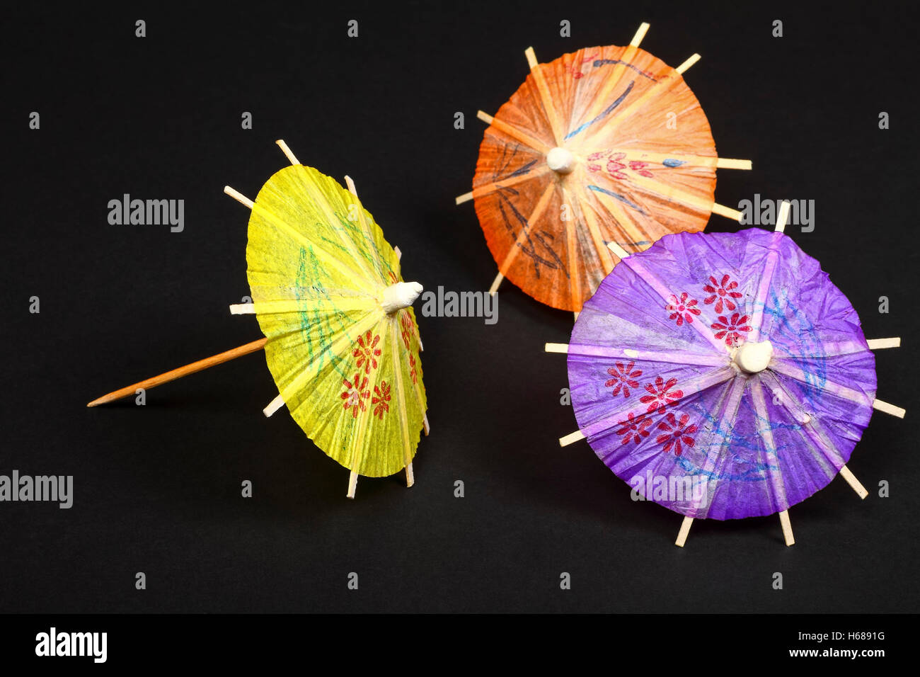 Cocktail umbrellas isolated on a black background Stock Photo