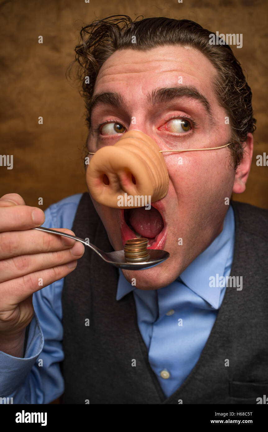 Silly pig man eating lose change for banking greed image Stock Photo ...