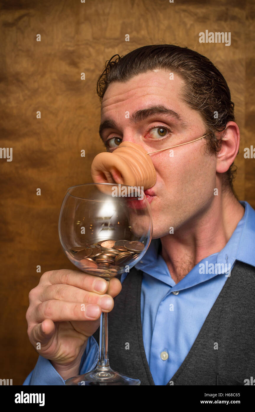 Silly pig man eating lose change for banking greed image Stock Photo ...