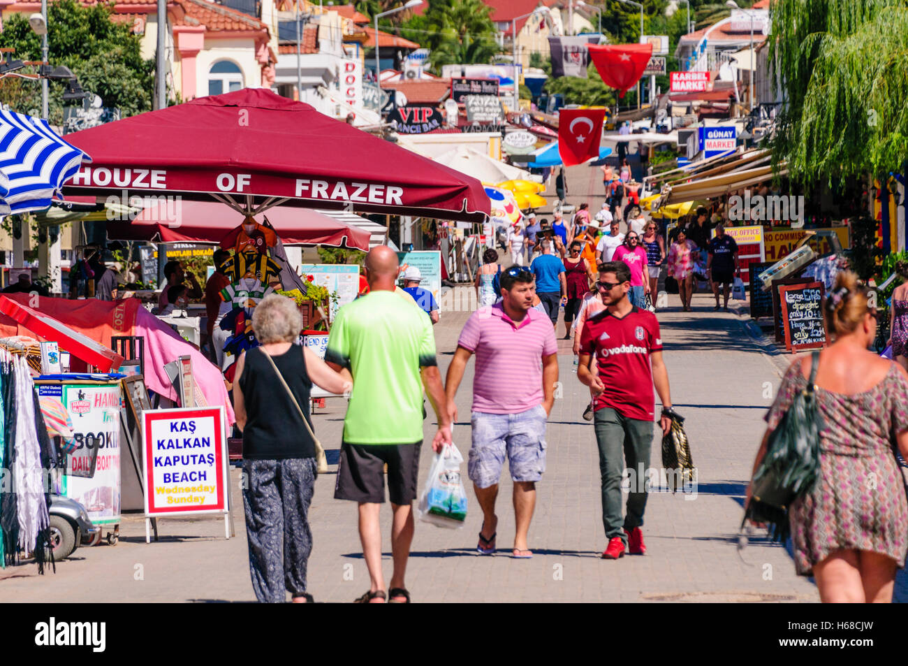 Tourists walking along the main shopping street in Oludeniz, Turkey, where there are many fake shops including Houze of Frazer Stock Photo