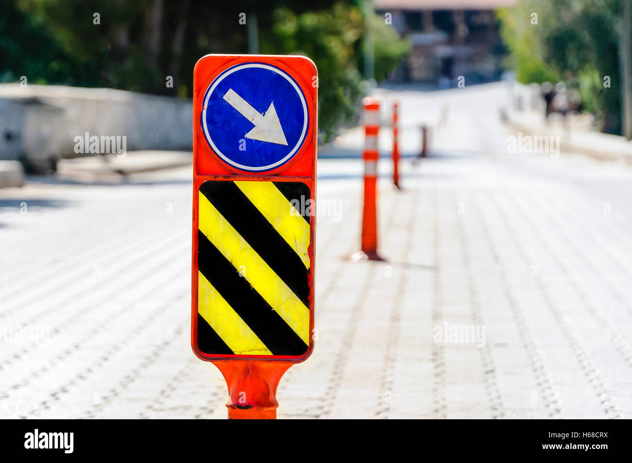 High visibility bollards down the middle of a road in Turkey, placed to try to ensure (unsuccessfully) that drivers stay on the Stock Photo