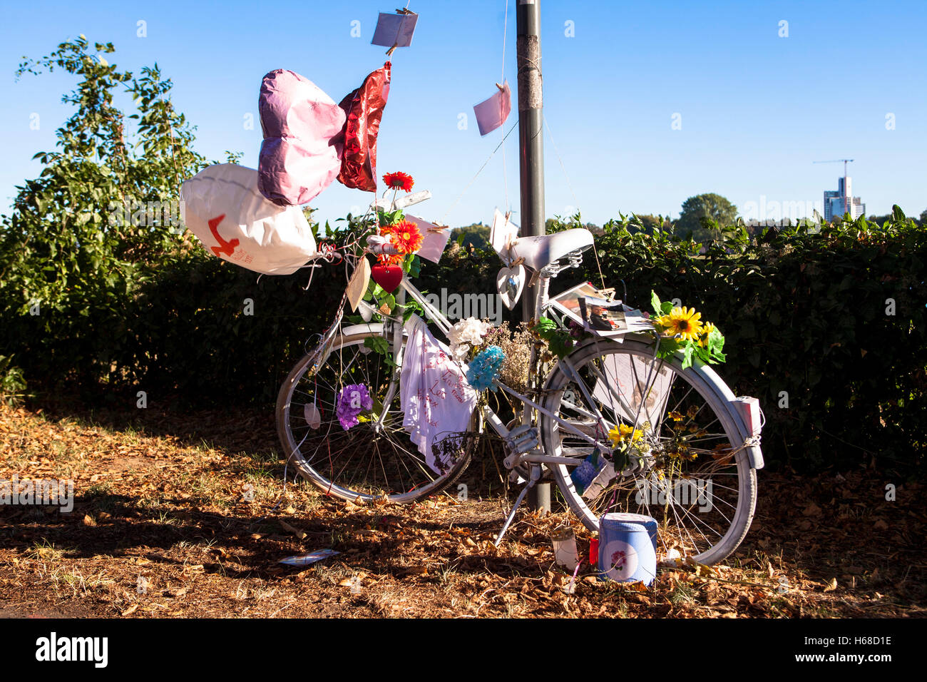 Germany, Cologne, ghost bike, white adorned bicycle reminds of a cyclist, who had a seriously or deadly accident at this place. Stock Photo