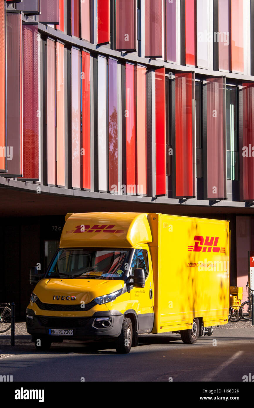 Germany, Cologne, DHL parcel service car in front of the office building Cologne Oval Offices. Stock Photo
