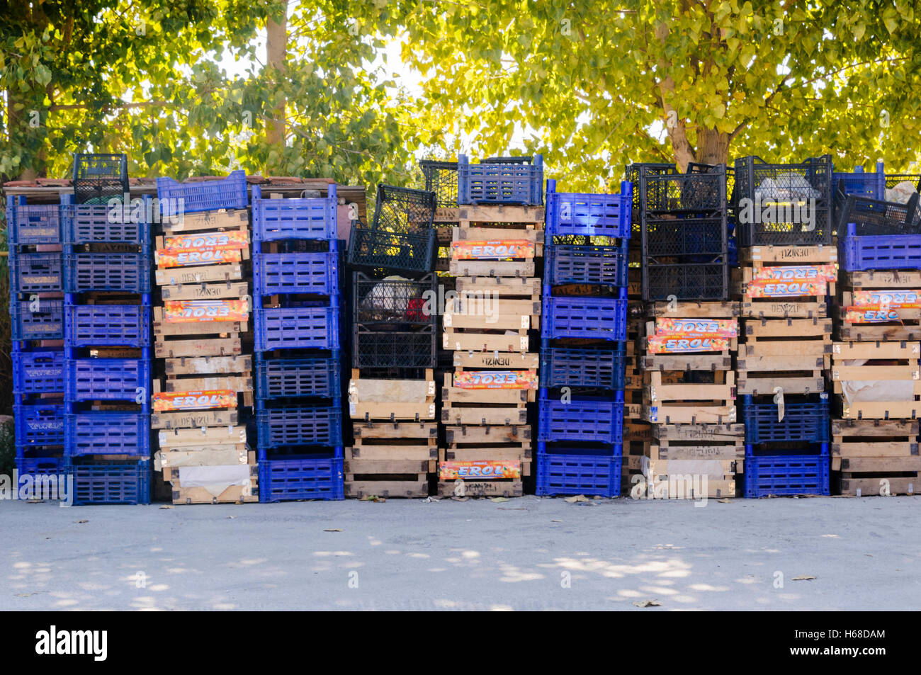 Stacks of wooden and plastic fruit crates behind a Turkish restaurant. Stock Photo