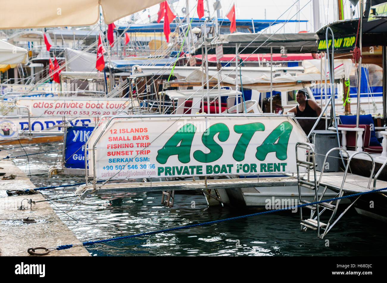 Signs on the gangways of boats offering private boat tours for tourists and visitors. Stock Photo