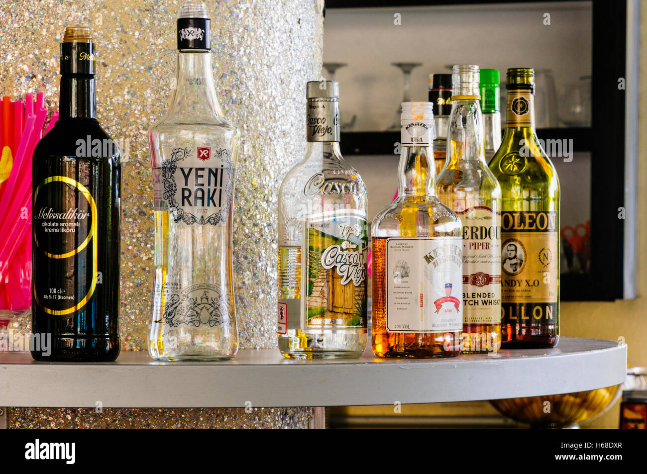 Spirits, including Raki, Vodka, Brandy, Scotch Whiskey, on the shelf of a bar in a Turkish all-inclusive hotel. Stock Photo