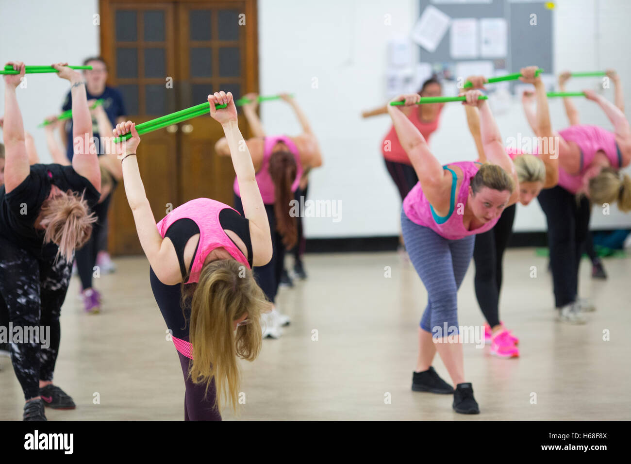 Women participating in POUND fitness class, hour long workout drumming