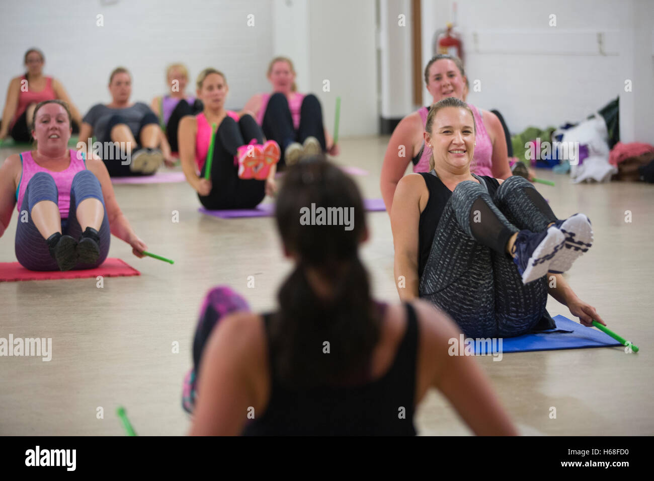 Women participating in POUND fitness class, hour long workout drumming