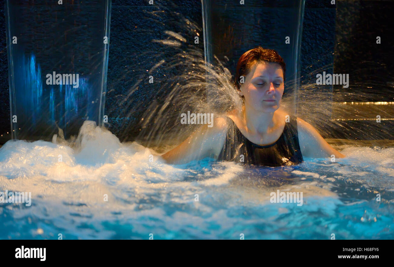 Woman relaxation in pool with waterfall Stock Photo - Alamy