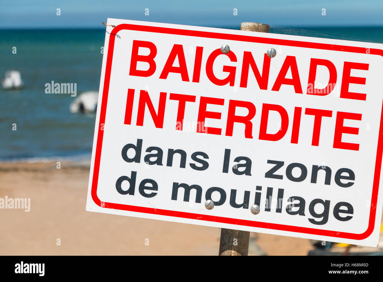 french sign "swimming prohibited in the boat launching area" planted in ...