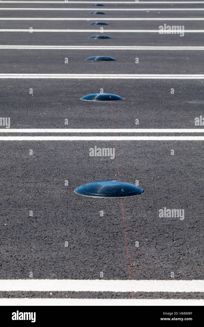 Electromagnetic car parking sensor to indicate where open parking is located on city streets Stock Photo