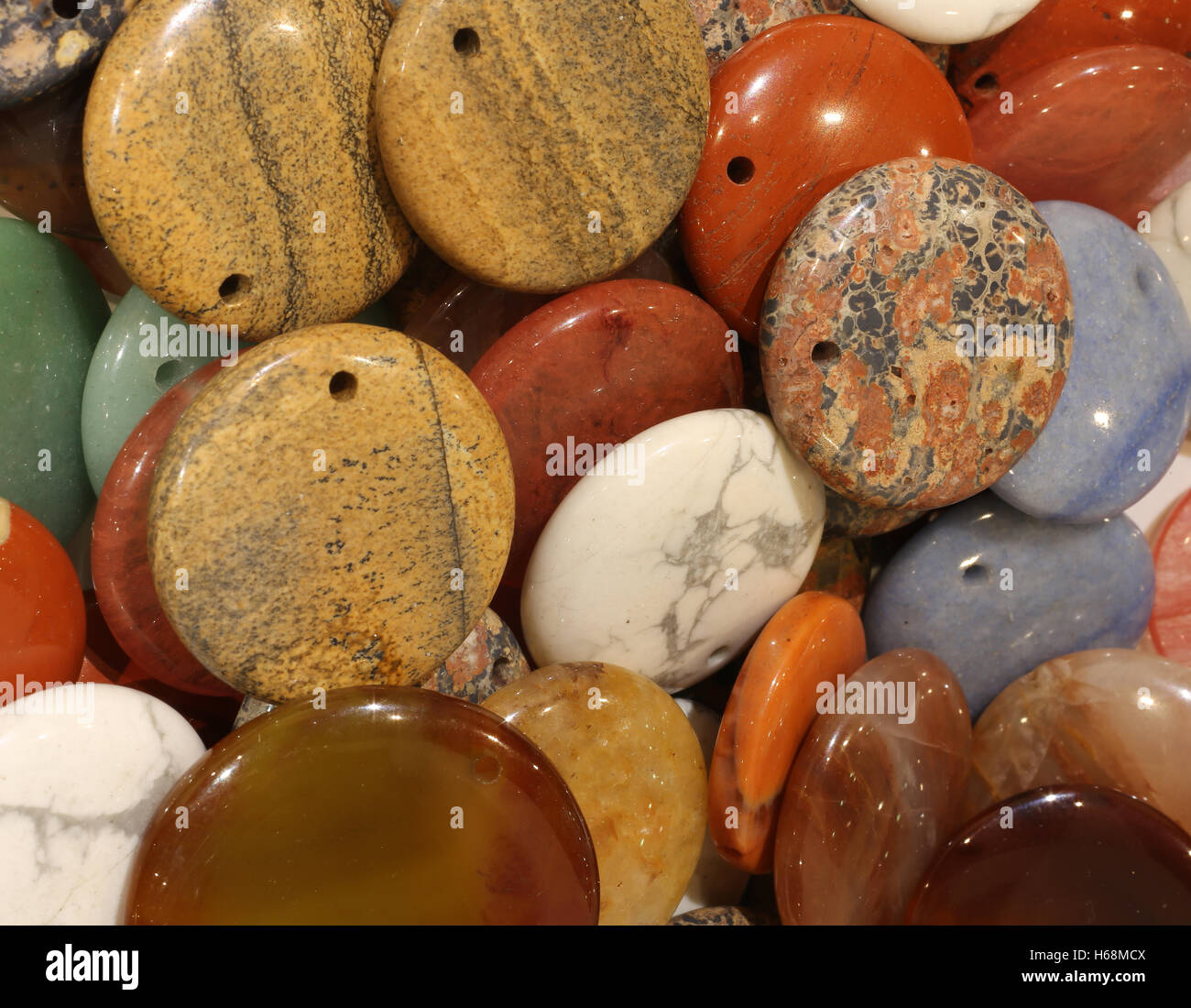 background of hard polished stones with hole for inserting a necklace